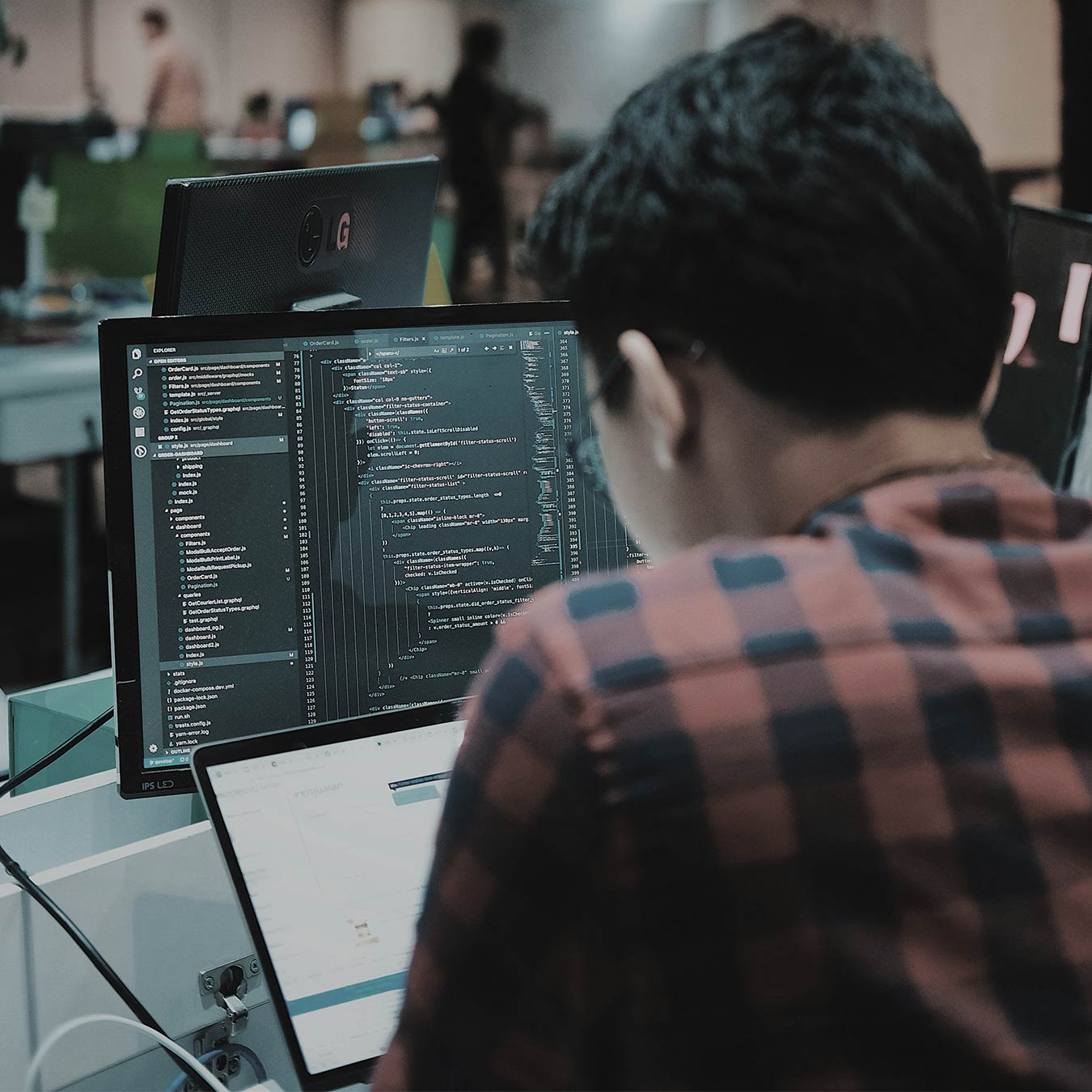 Developer coding custom web and app development solutions for B2B business